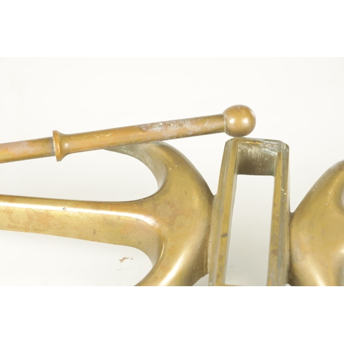 663 - A LATE 19TH CENTURY BRASS HANGING BRACKET with anchors and a pulley to each end. (58cm wide)