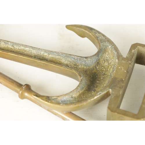 663 - A LATE 19TH CENTURY BRASS HANGING BRACKET with anchors and a pulley to each end. (58cm wide)