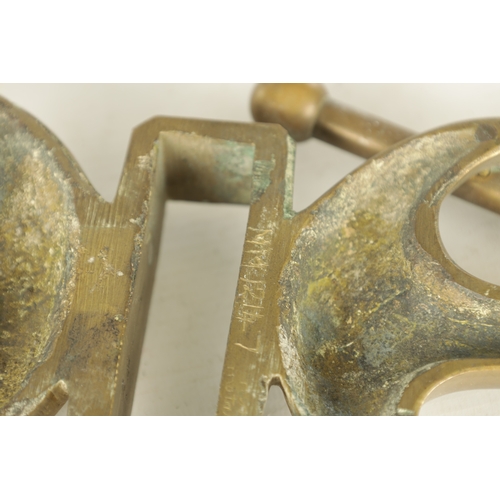 663 - A LATE 19TH CENTURY BRASS HANGING BRACKET with anchors and a pulley to each end. (58cm wide)