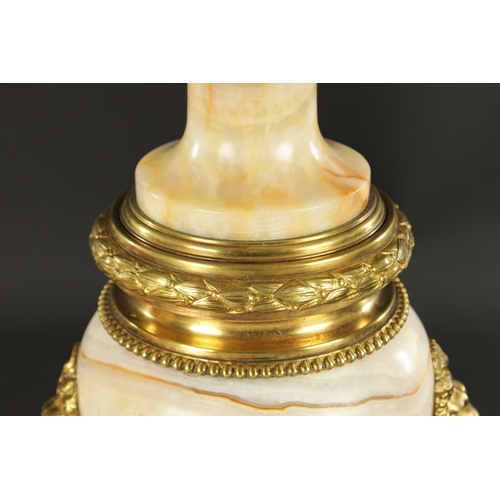 674 - A PAIR OF LATE 19TH CENTURY ONYX AND ORMOLU MOUNTED CASSOLETTES of unusual shape with bulbous bodies... 