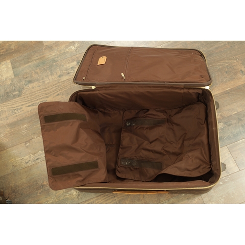 676 - A GENUINE LOUIS VUITTON SUITCASE with monogrammed decoration and brown leather carrying handle. (68c... 