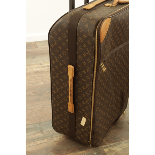 676 - A GENUINE LOUIS VUITTON SUITCASE with monogrammed decoration and brown leather carrying handle. (68c... 