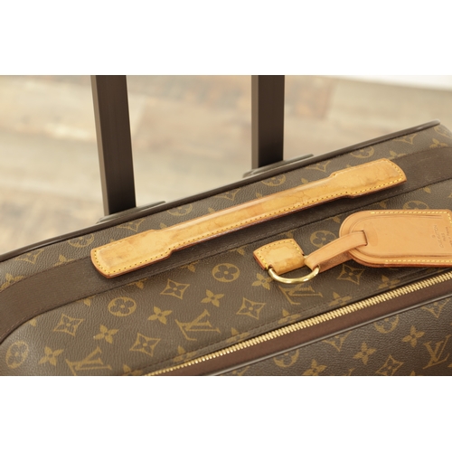 676 - A GENUINE LOUIS VUITTON SUITCASE with monogrammed decoration and brown leather carrying handle. (68c... 