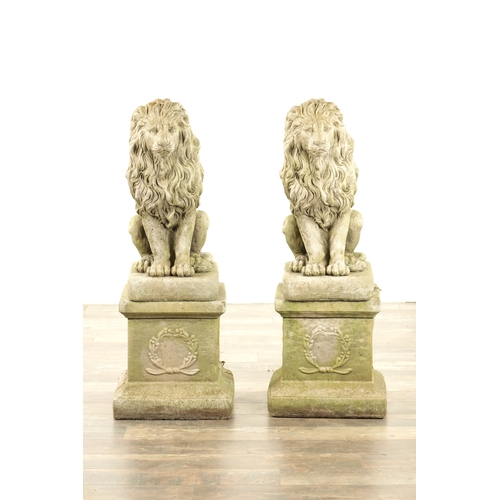 677 - A PAIR OF MODERN COMPOSITE STONE LIONS in seated position raised on square plinth bases (92cm high)