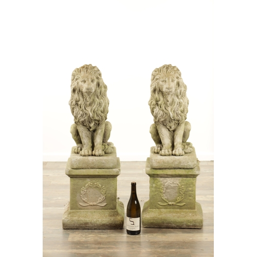 677 - A PAIR OF MODERN COMPOSITE STONE LIONS in seated position raised on square plinth bases (92cm high)