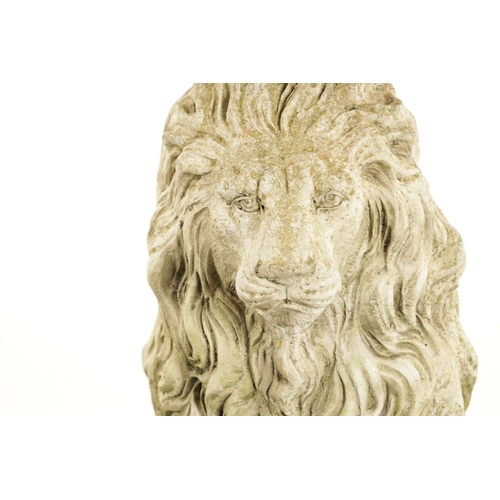 677 - A PAIR OF MODERN COMPOSITE STONE LIONS in seated position raised on square plinth bases (92cm high)