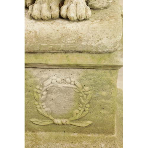 677 - A PAIR OF MODERN COMPOSITE STONE LIONS in seated position raised on square plinth bases (92cm high)