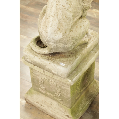 677 - A PAIR OF MODERN COMPOSITE STONE LIONS in seated position raised on square plinth bases (92cm high)