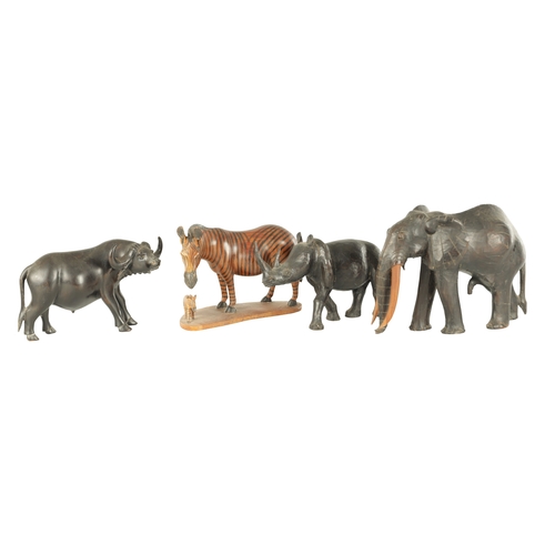 685 - A COLLECTION OF CARVED AFRICAN ANIMALS comprising of a water buffalo, an elephant, zebra and a rhino... 