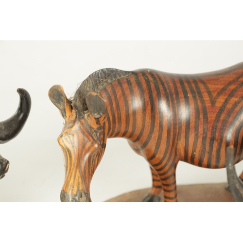 685 - A COLLECTION OF CARVED AFRICAN ANIMALS comprising of a water buffalo, an elephant, zebra and a rhino... 