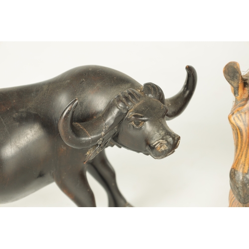 685 - A COLLECTION OF CARVED AFRICAN ANIMALS comprising of a water buffalo, an elephant, zebra and a rhino... 