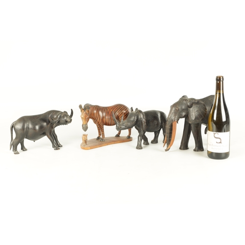 685 - A COLLECTION OF CARVED AFRICAN ANIMALS comprising of a water buffalo, an elephant, zebra and a rhino... 