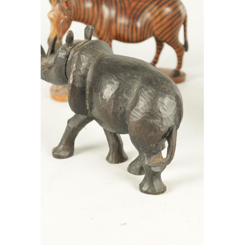 685 - A COLLECTION OF CARVED AFRICAN ANIMALS comprising of a water buffalo, an elephant, zebra and a rhino... 