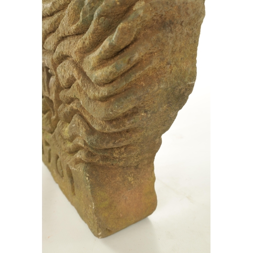 692 - AN EARLY 18TH CENTURY CARVED SANDSTONE SCULPTURE OF A PAGAN SUN GOD dated 1701 (60cm wide 40cm high ... 