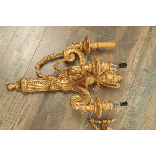 696 - A SET OF FOUR CARVED GILTWOOD ADAM STYLE HANGING WALL LIGHTS with urn-shaped leaf-carved bodies havi... 