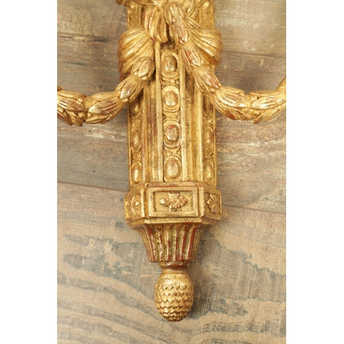 696 - A SET OF FOUR CARVED GILTWOOD ADAM STYLE HANGING WALL LIGHTS with urn-shaped leaf-carved bodies havi... 