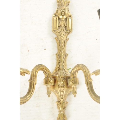 701 - A PAIR OF 20TH CENTURY GILT BRASS WALL LIGHTS with two leaf cast branches (31cm overall )