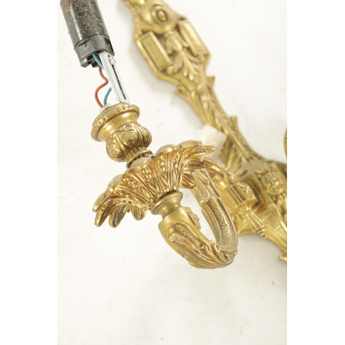 701 - A PAIR OF 20TH CENTURY GILT BRASS WALL LIGHTS with two leaf cast branches (31cm overall )