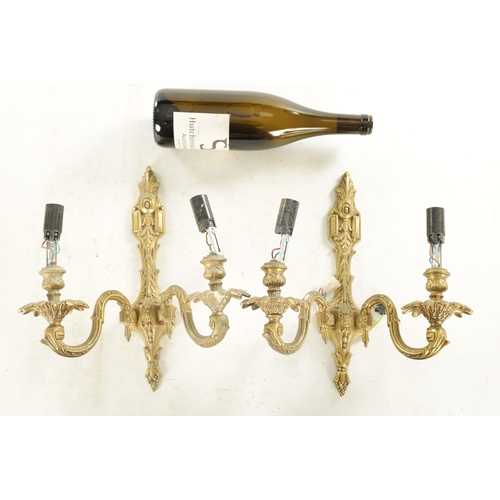 701 - A PAIR OF 20TH CENTURY GILT BRASS WALL LIGHTS with two leaf cast branches (31cm overall )