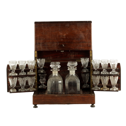 702 - A LATE 19TH CENTURY ROSEWOOD LIQUOR DECANTER BOX with a strung body, locking hinged lid and fold-dow... 