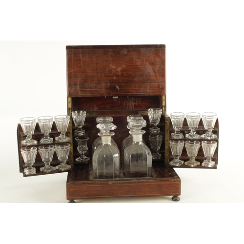 702 - A LATE 19TH CENTURY ROSEWOOD LIQUOR DECANTER BOX with a strung body, locking hinged lid and fold-dow... 