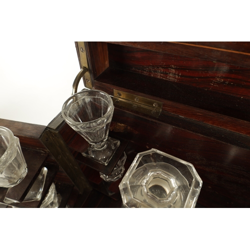 702 - A LATE 19TH CENTURY ROSEWOOD LIQUOR DECANTER BOX with a strung body, locking hinged lid and fold-dow... 