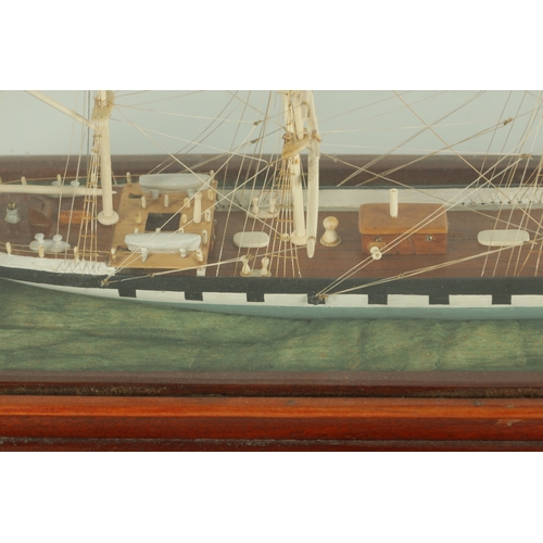 703 - A 19TH CENTURY SAILOR MADE CASED MODEL OF A FOUR MASTED SCHOONER SHIP, with bone masts and painted w... 