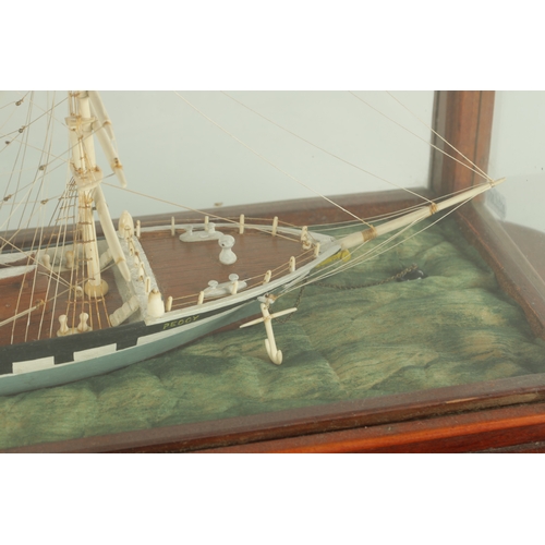 703 - A 19TH CENTURY SAILOR MADE CASED MODEL OF A FOUR MASTED SCHOONER SHIP, with bone masts and painted w... 