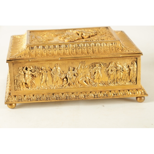 707 - A LATE 19TH CENTURY FRENCH GILT METAL JEWELLERY CASKET with classical figural scenes raised on bun f... 