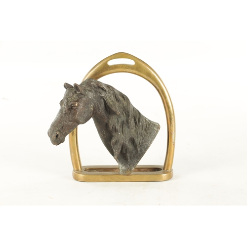 709 - A 19TH CENTURY FRENCH CAST BRONZE DOORSTOP FORMED AS A HORSE'S HEAD with a stirrup handle - signed t... 