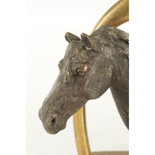 709 - A 19TH CENTURY FRENCH CAST BRONZE DOORSTOP FORMED AS A HORSE'S HEAD with a stirrup handle - signed t... 