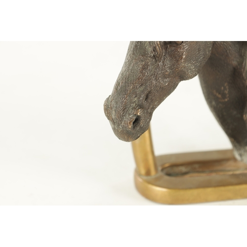 709 - A 19TH CENTURY FRENCH CAST BRONZE DOORSTOP FORMED AS A HORSE'S HEAD with a stirrup handle - signed t... 