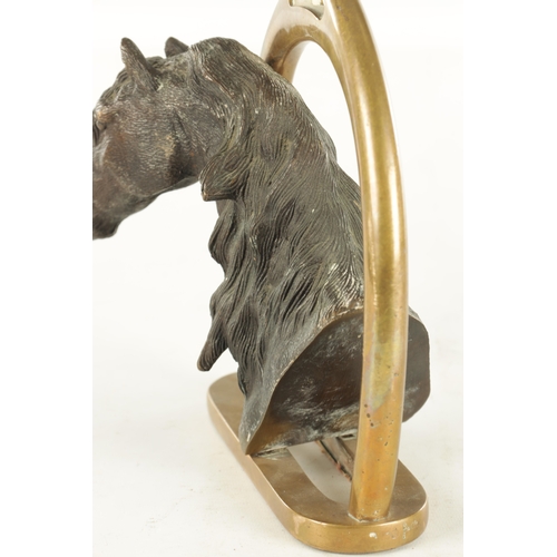 709 - A 19TH CENTURY FRENCH CAST BRONZE DOORSTOP FORMED AS A HORSE'S HEAD with a stirrup handle - signed t... 