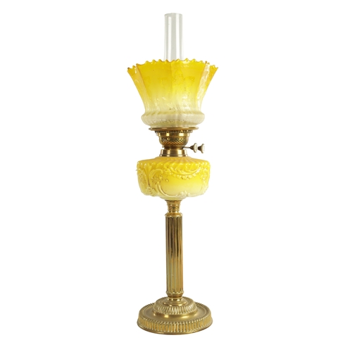 713 - A FINE VICTORIAN BRASS AND YELLOW GLASS OIL LAMP the stepped circular gadroon-edged base with reeded... 