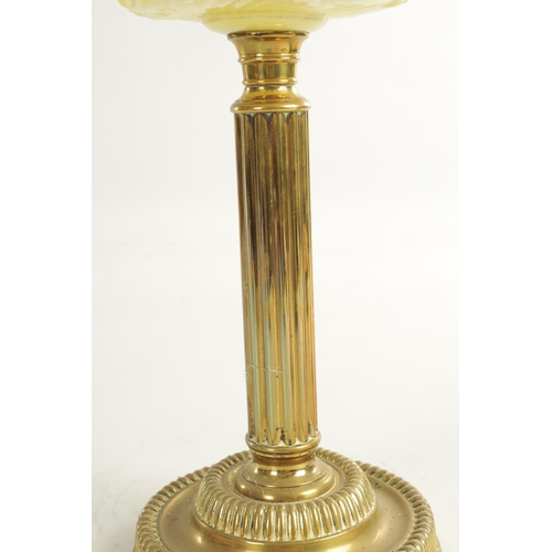 713 - A FINE VICTORIAN BRASS AND YELLOW GLASS OIL LAMP the stepped circular gadroon-edged base with reeded... 