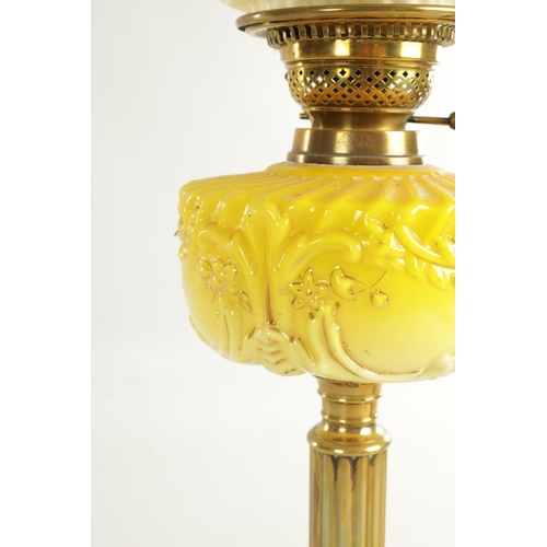 713 - A FINE VICTORIAN BRASS AND YELLOW GLASS OIL LAMP the stepped circular gadroon-edged base with reeded... 