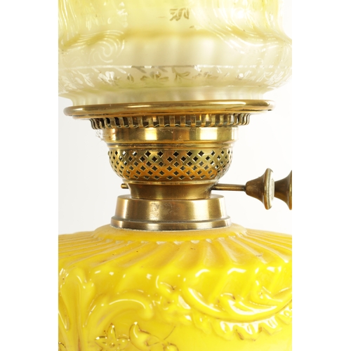 713 - A FINE VICTORIAN BRASS AND YELLOW GLASS OIL LAMP the stepped circular gadroon-edged base with reeded... 