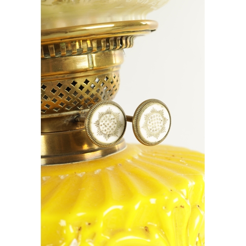 713 - A FINE VICTORIAN BRASS AND YELLOW GLASS OIL LAMP the stepped circular gadroon-edged base with reeded... 