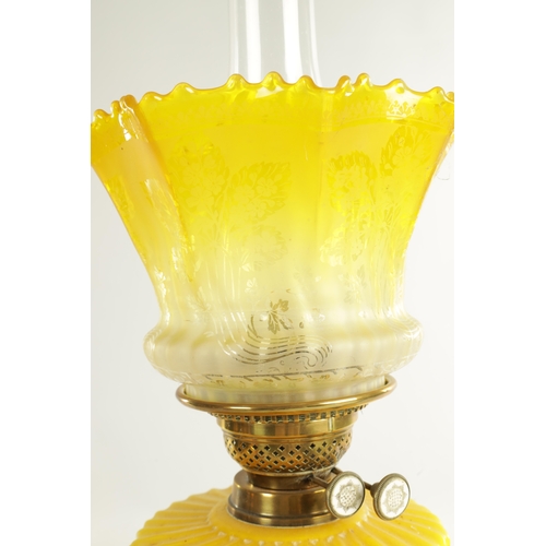 713 - A FINE VICTORIAN BRASS AND YELLOW GLASS OIL LAMP the stepped circular gadroon-edged base with reeded... 