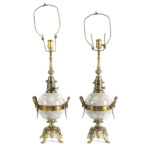 718 - A PAIR OF LATE 19TH CENTURY CAST GILT BRASS AND PORCELAIN OIL LAMPS CONVERTED FOR ELECTRICITY of ela... 