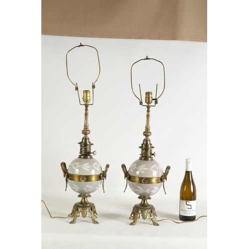 718 - A PAIR OF LATE 19TH CENTURY CAST GILT BRASS AND PORCELAIN OIL LAMPS CONVERTED FOR ELECTRICITY of ela... 