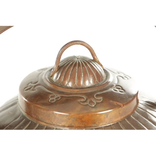 719 - A LARGE ARTS AND CRAFTS COPPER KETTLE with an iron-hinged handle and domed lid, the body decorated w... 