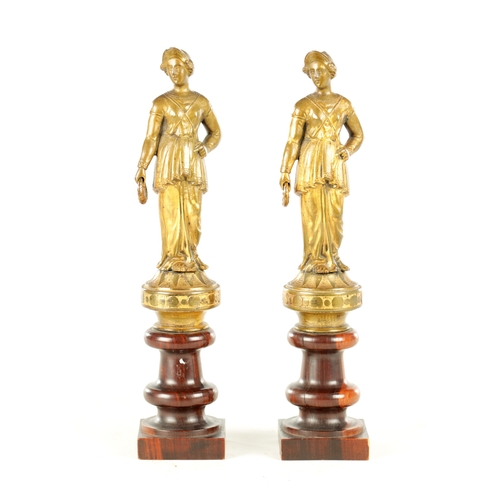 722 - A PAIR OF 19TH CENTURY FRENCH GILT BRONZE FIGURAL SCULPTURES each modelled as a classical lady holdi... 