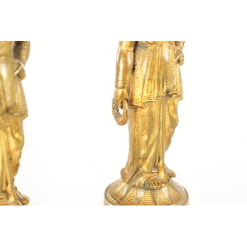 722 - A PAIR OF 19TH CENTURY FRENCH GILT BRONZE FIGURAL SCULPTURES each modelled as a classical lady holdi... 