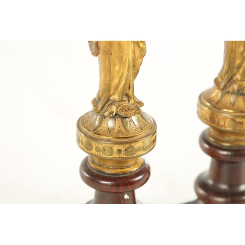 722 - A PAIR OF 19TH CENTURY FRENCH GILT BRONZE FIGURAL SCULPTURES each modelled as a classical lady holdi... 