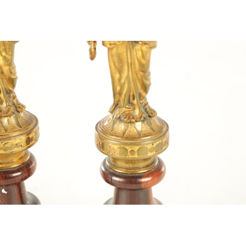 722 - A PAIR OF 19TH CENTURY FRENCH GILT BRONZE FIGURAL SCULPTURES each modelled as a classical lady holdi... 