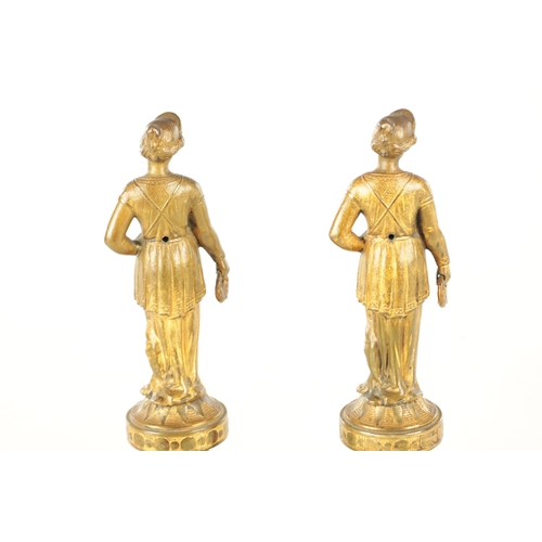 722 - A PAIR OF 19TH CENTURY FRENCH GILT BRONZE FIGURAL SCULPTURES each modelled as a classical lady holdi... 