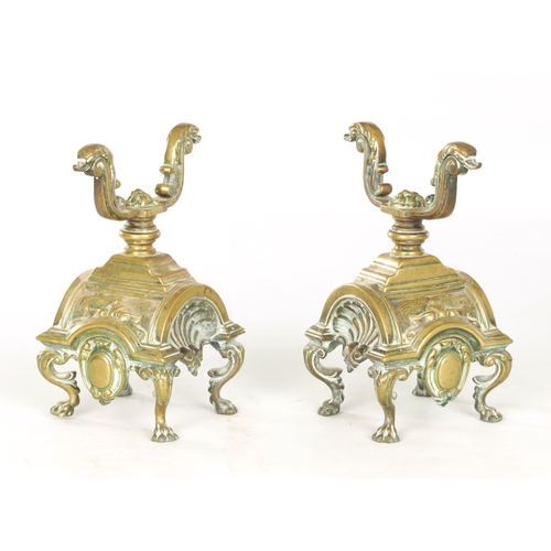 729 - A PAIR OF LATE 19TH CENTURY BRASS FIRE DOGS with arched shell bodies raised on lions paw feet (23cm ... 