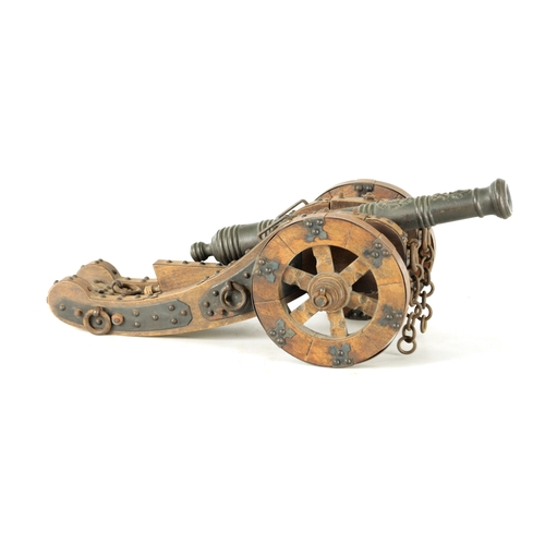 732 - A 20TH CENTURY BRONZE MODEL OF A CANNON mounted on a wooden carriage with steel decoration (37cm wid... 