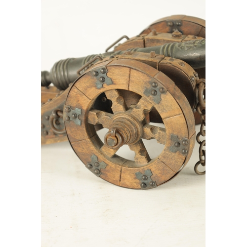 732 - A 20TH CENTURY BRONZE MODEL OF A CANNON mounted on a wooden carriage with steel decoration (37cm wid... 